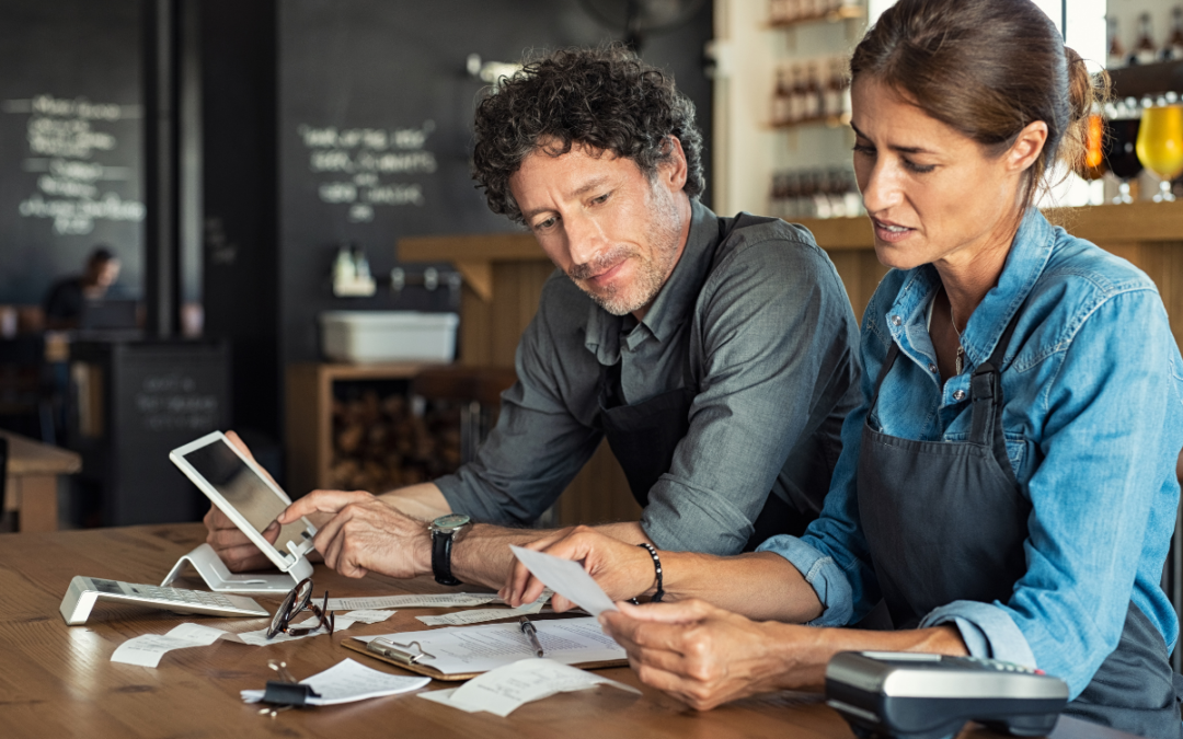 Meritus Group professionals discussing a small business sale, highlighting their specialization in helping small businesses achieve optimal value.