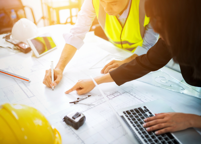 Engineer reviewing blueprints, highlighting the seamless sale of an engineering firm in South Dakota, Minnesota, Iowa, Nebraska, and Wisconsin with Meritus Group Business Brokerage.