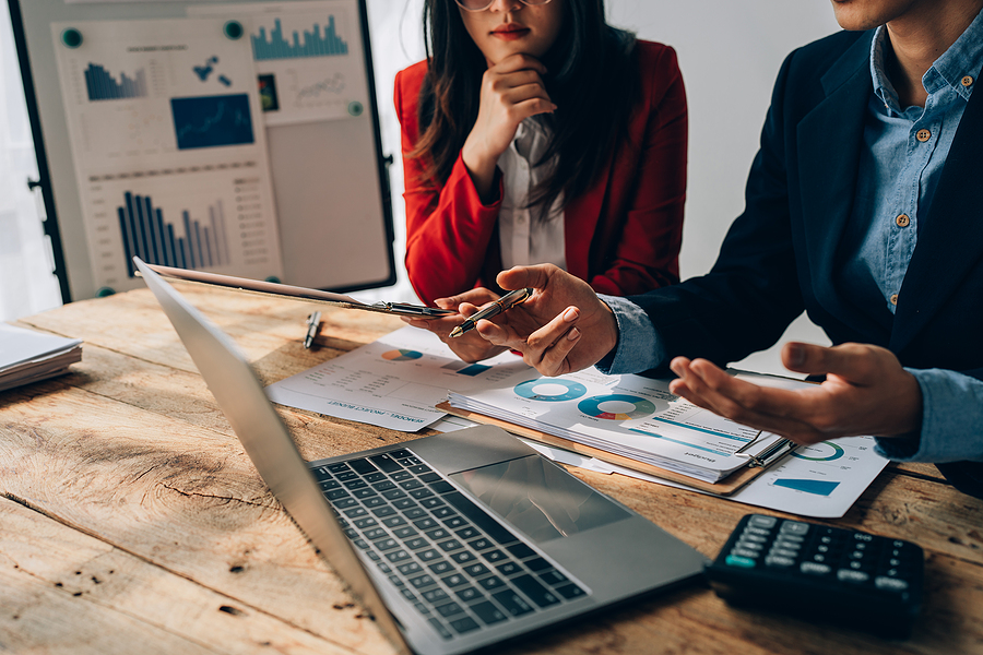 Woman examining business documents and charts